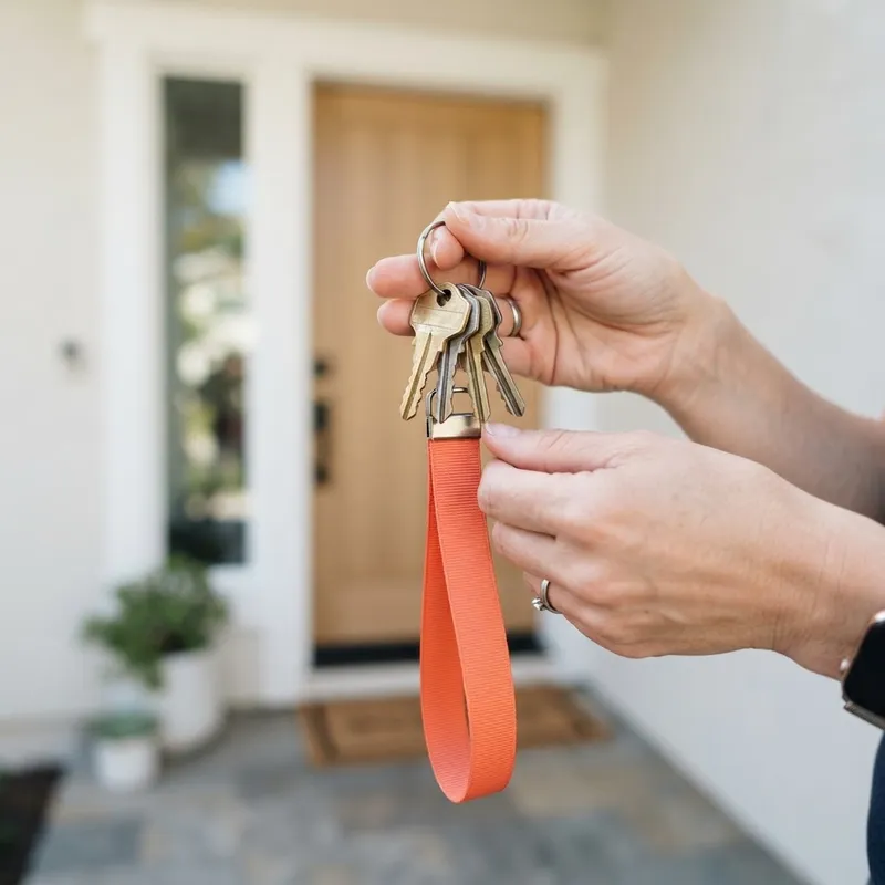 A close up view of hands holding new house keys